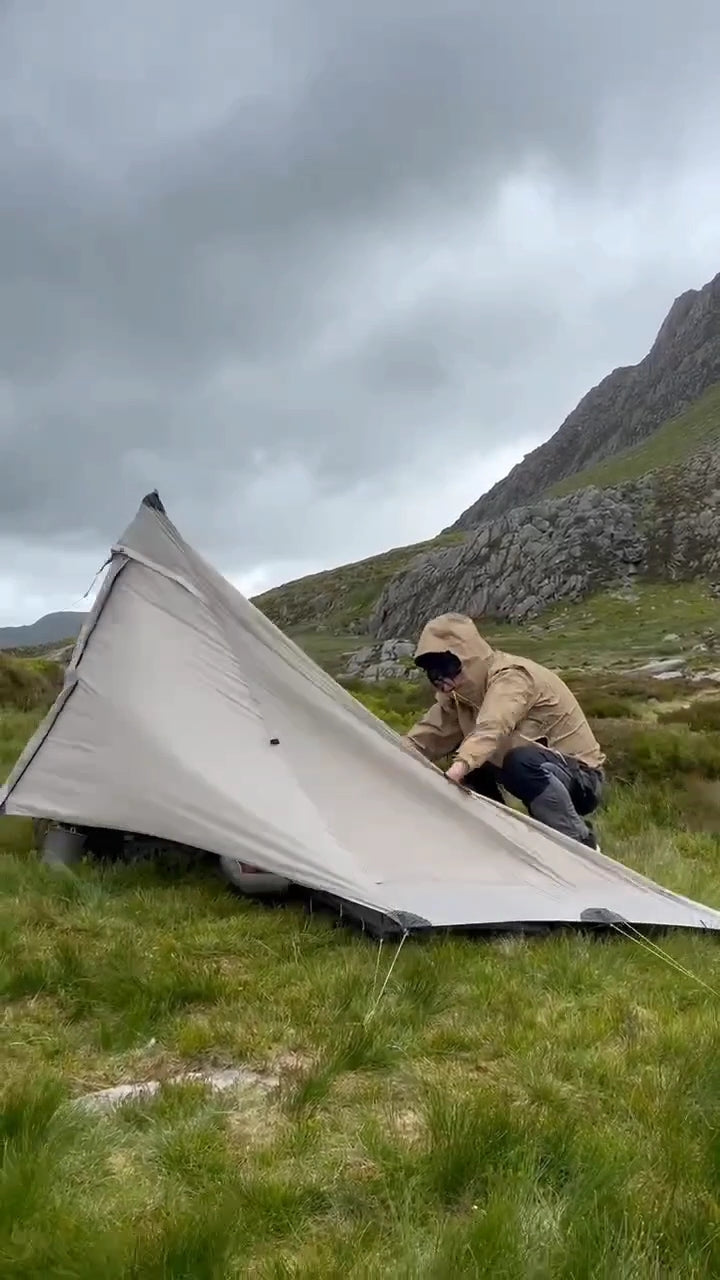 Mountain tent pitched in a sheltered wild-camping location