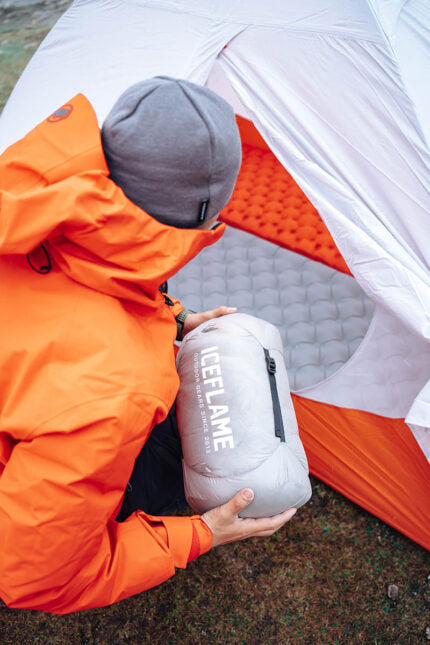 Iceflame Flame NXT backpacking sleeping bag – packed beside tent