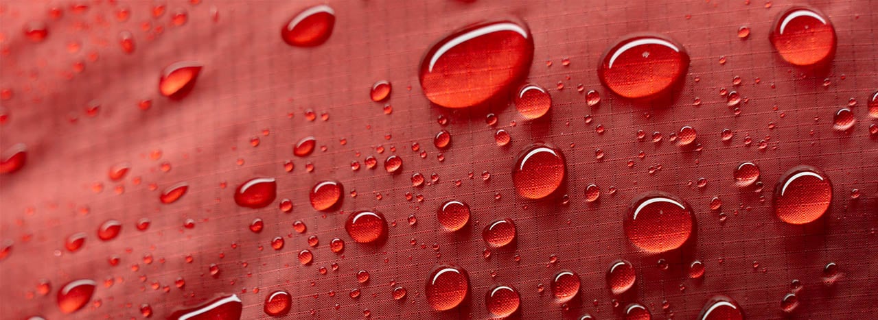 Water droplets on red outdoor fabric